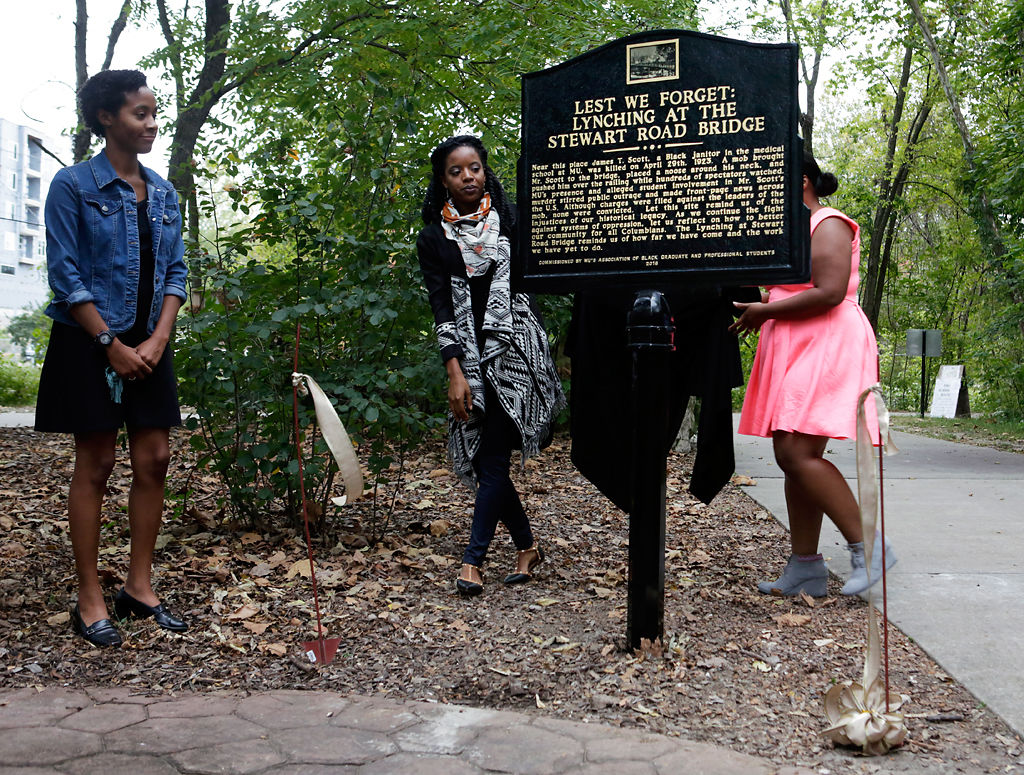 A marker stands on the MKT Trail